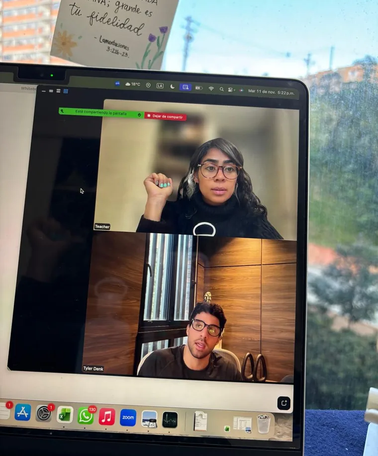 Laptop showing a live online Spanish class on a video call